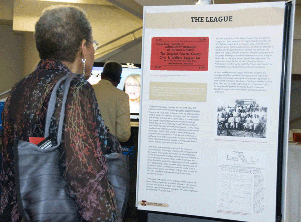 Attendee views a panel from the Uplift the Vote exhibit at the Ned McWherter library. Fall 2018.
