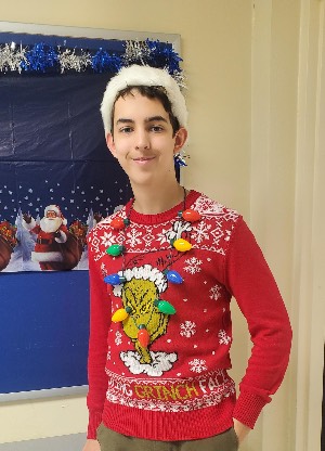 Christian Morrison wearing his "ugly sweater" featuring the Grinch