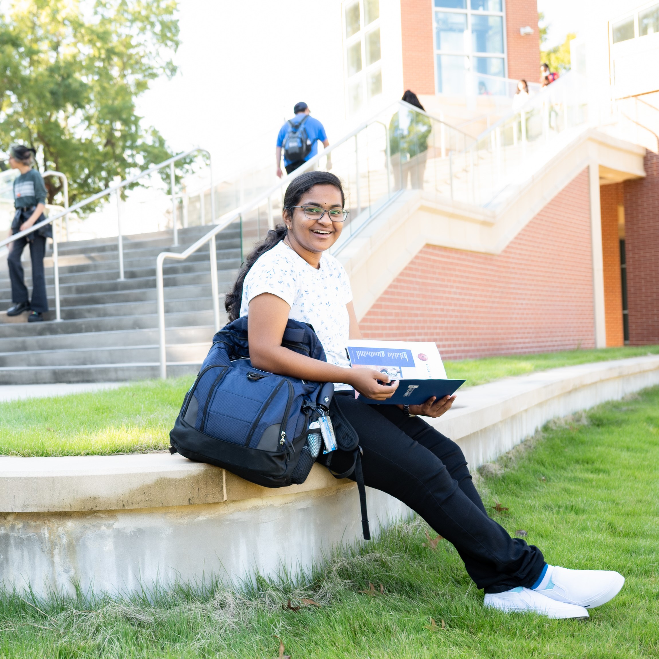 Smiling student sitting on steps