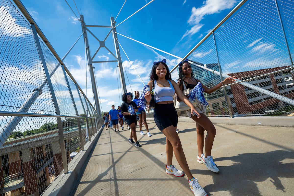 students crossing bridge