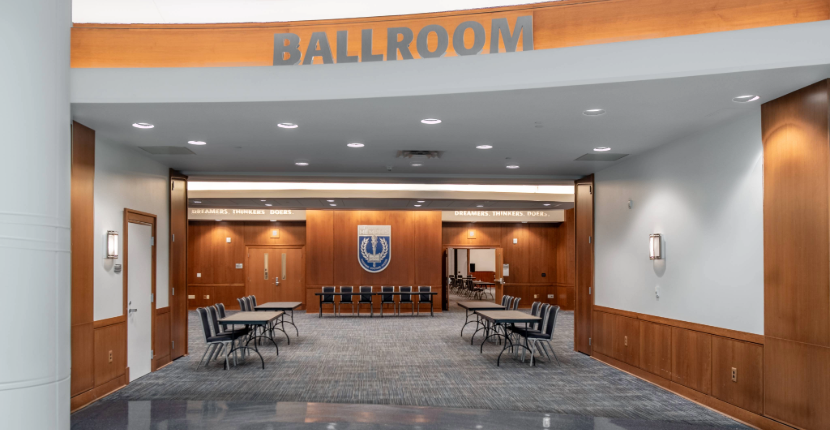 entry to UC Ballroom showing trade show setup with tables and chairs