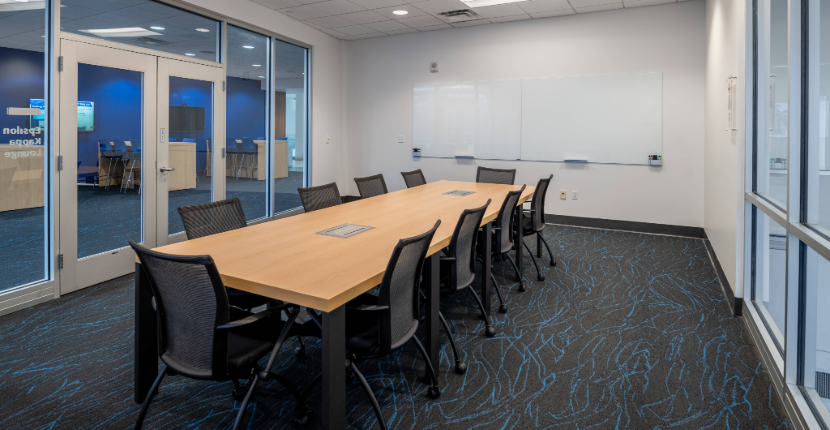 View of Conference Room 201 showing the table and white board