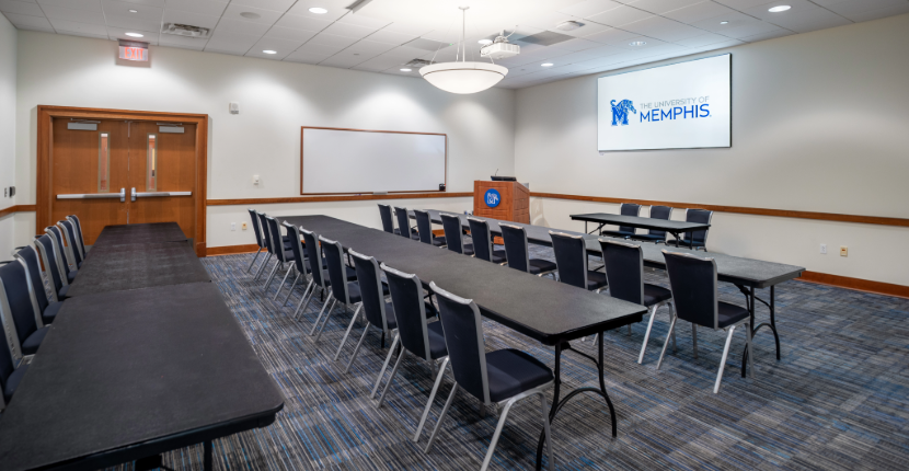 photo of the Iris room set in classroom style with screen and whiteboard