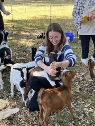 Woman plays with goats Woman plays with goats
