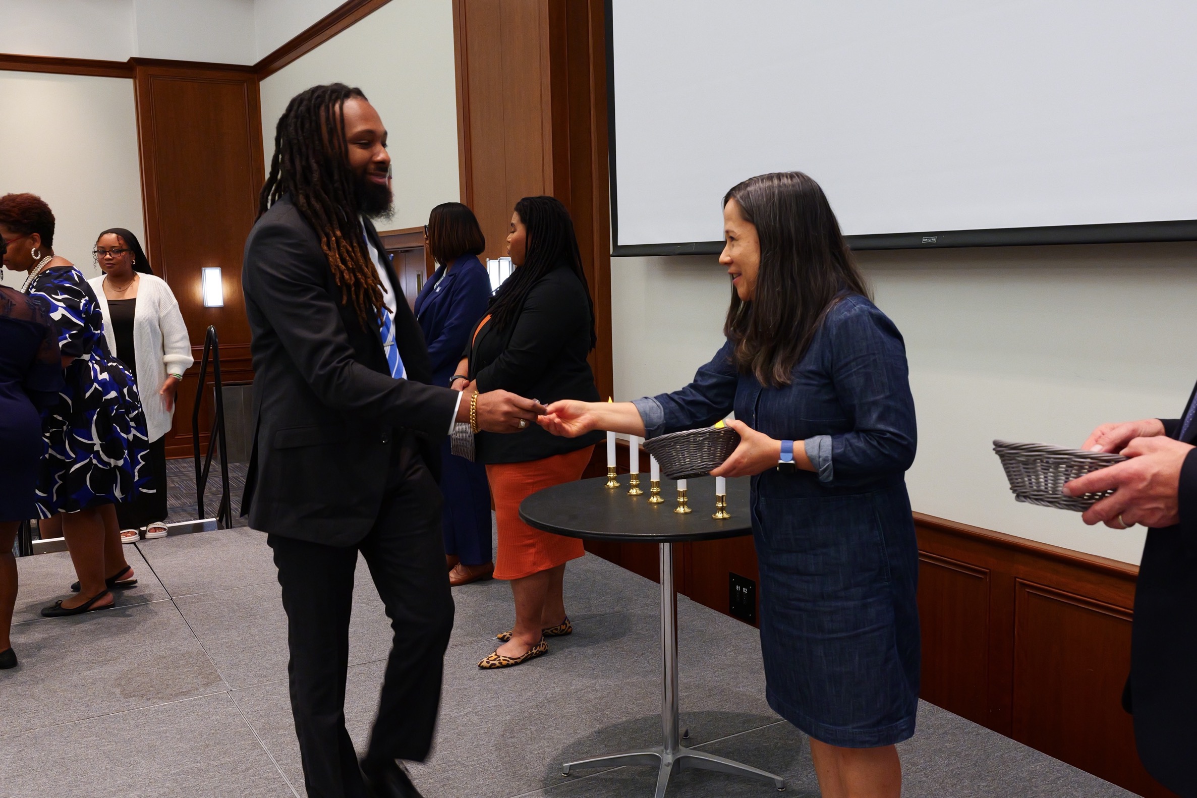 student shaking hand with presenter