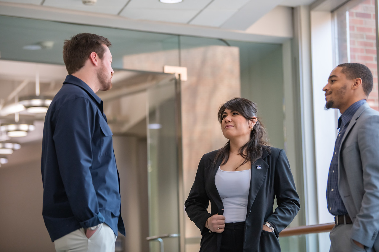 three students talking