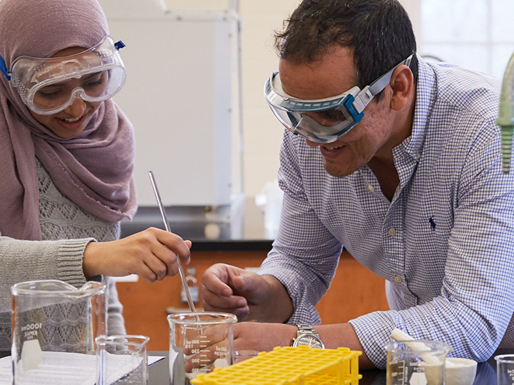 student and teacher in chemistry lab
