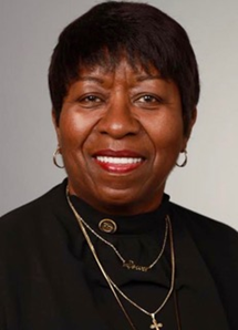 Headshot of Ella H. She is an elegant looking African-American woman.