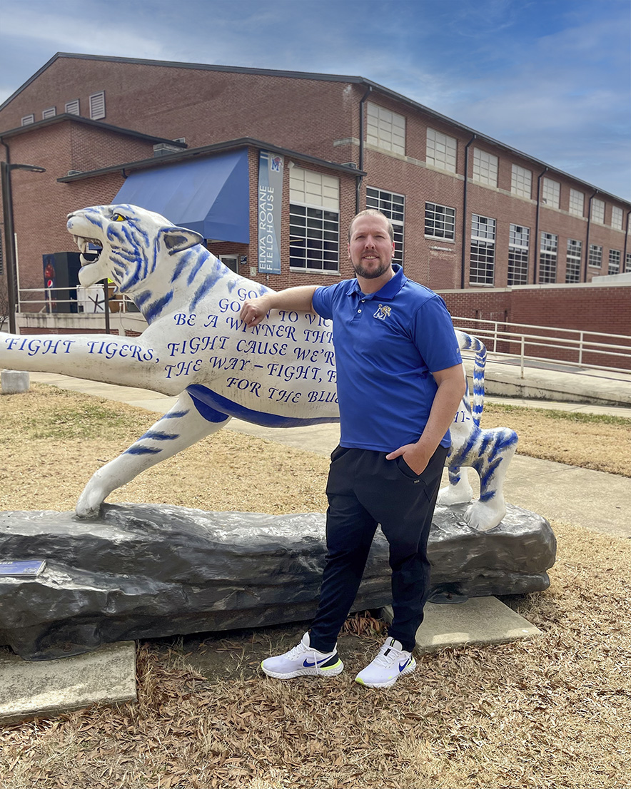Stephen Dowda stand by Tiger statue on UofM campus Stephen Dowda