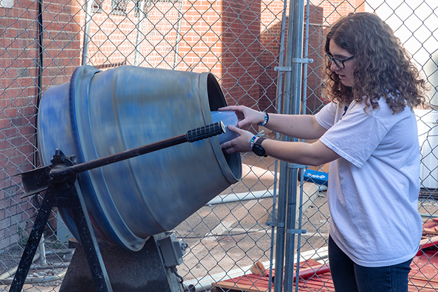 student mixing concrete in lab