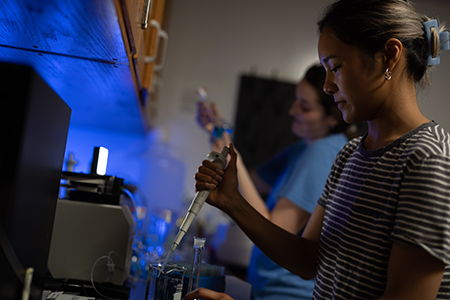 girl using a syringe in lab