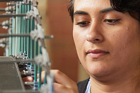 student working on model of a bridge