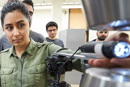 student working on machine in lab