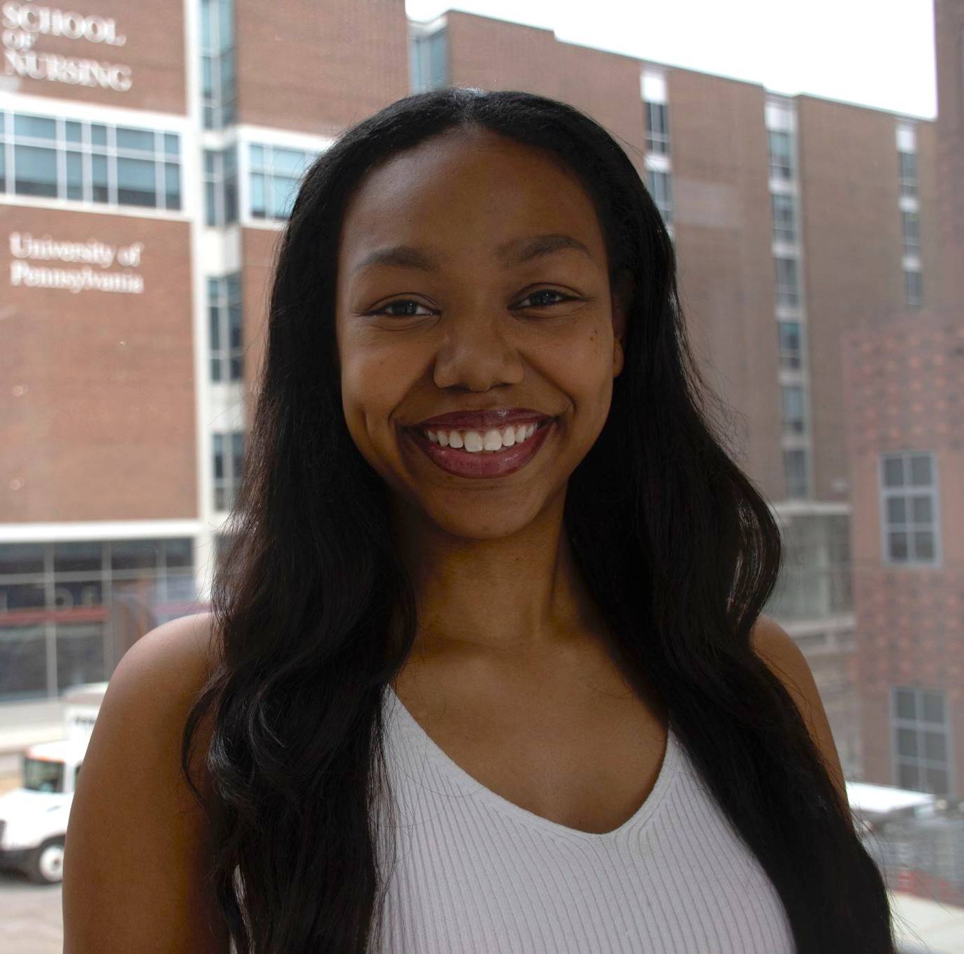 Alumni in front of campus building