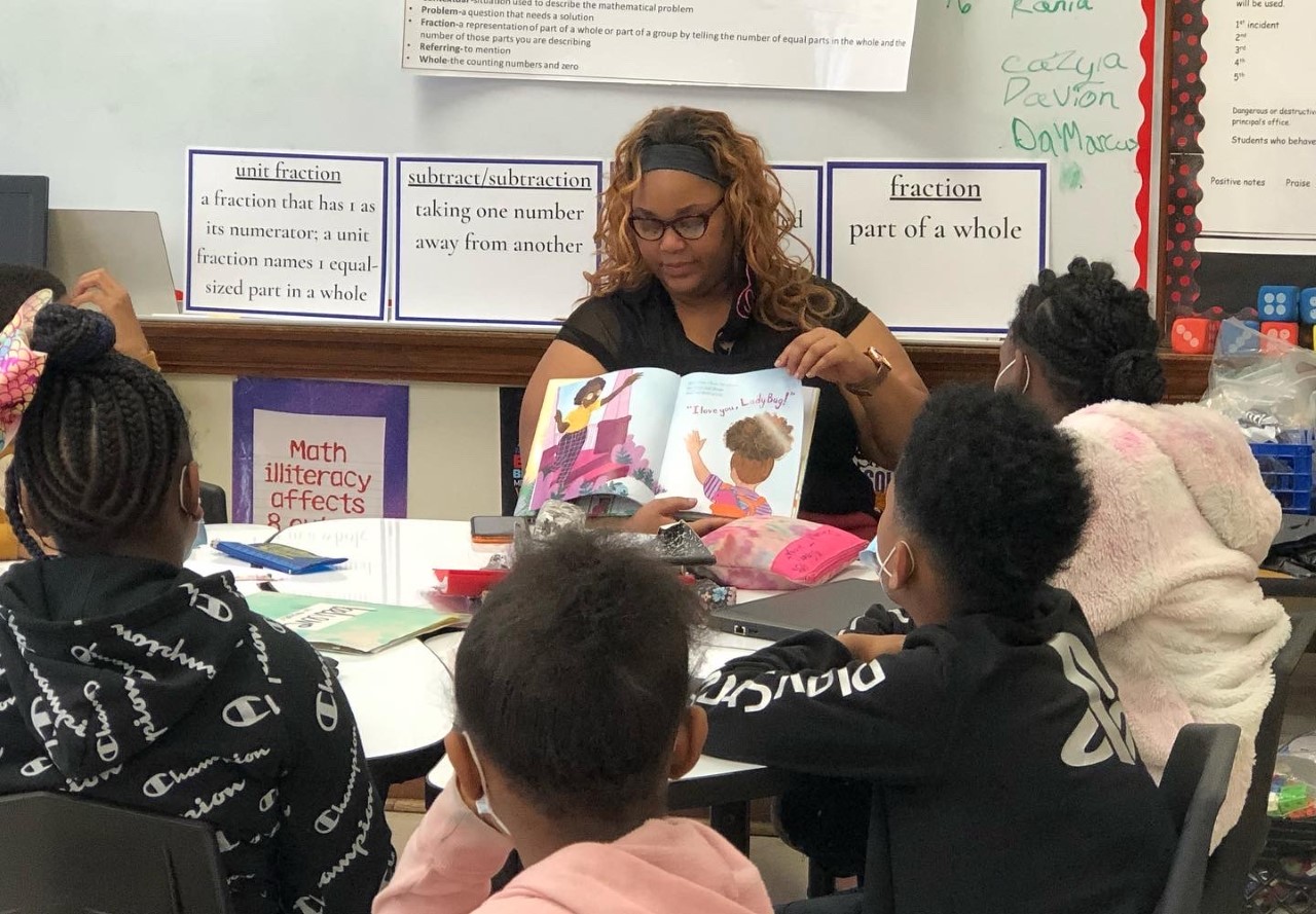 COE Student teacher reading to elementary students