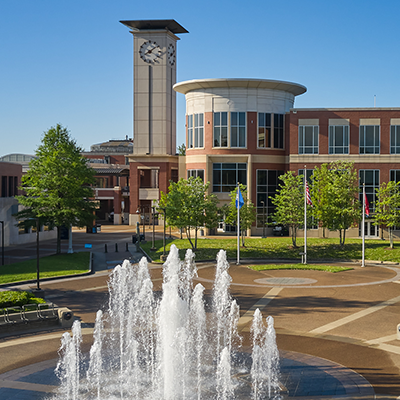 Fountain in the foreground and the Maxine A. Smith University Center and clocktower in the background on the UofM campus