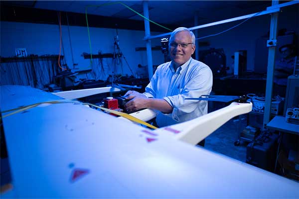 Eddie Jacobs works on a drone's camera