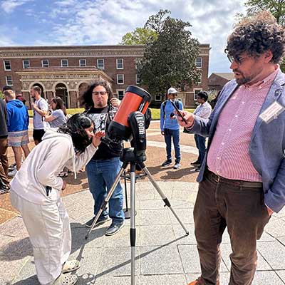 UofM views partial eclipse through telescope