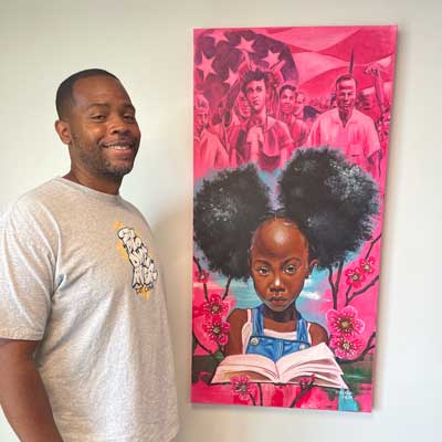 Artist D.Weaver with his art piece, &quot;The Story is Not Over&quot;