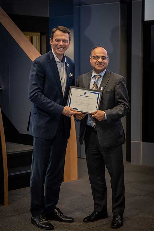 President Hardgrave presents Dean Joshi with an award
