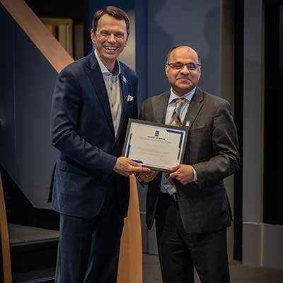President Hardgrave presents Dean Joshi with an award