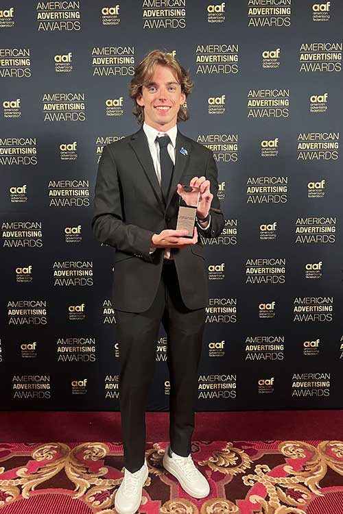 Zach Wall holding his ADDY award