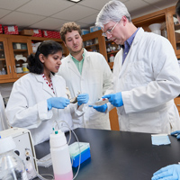 university of memphis students and professor in science lab