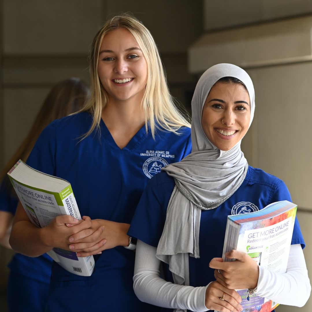Two Students Holding Books