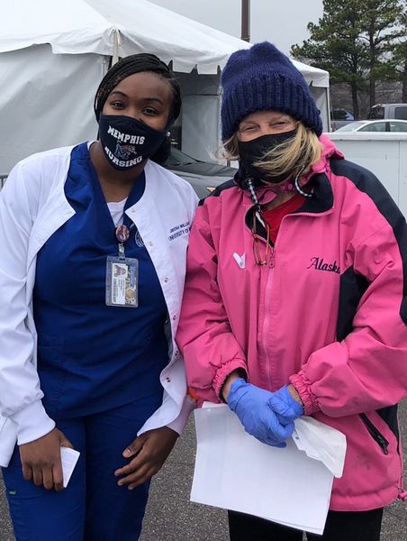 Professor Cotham with student outside vaccination tent Professor Cotham and student posing at Whitehaven Vaccination site