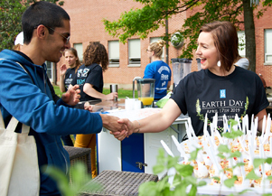 Students shaking hands at a table