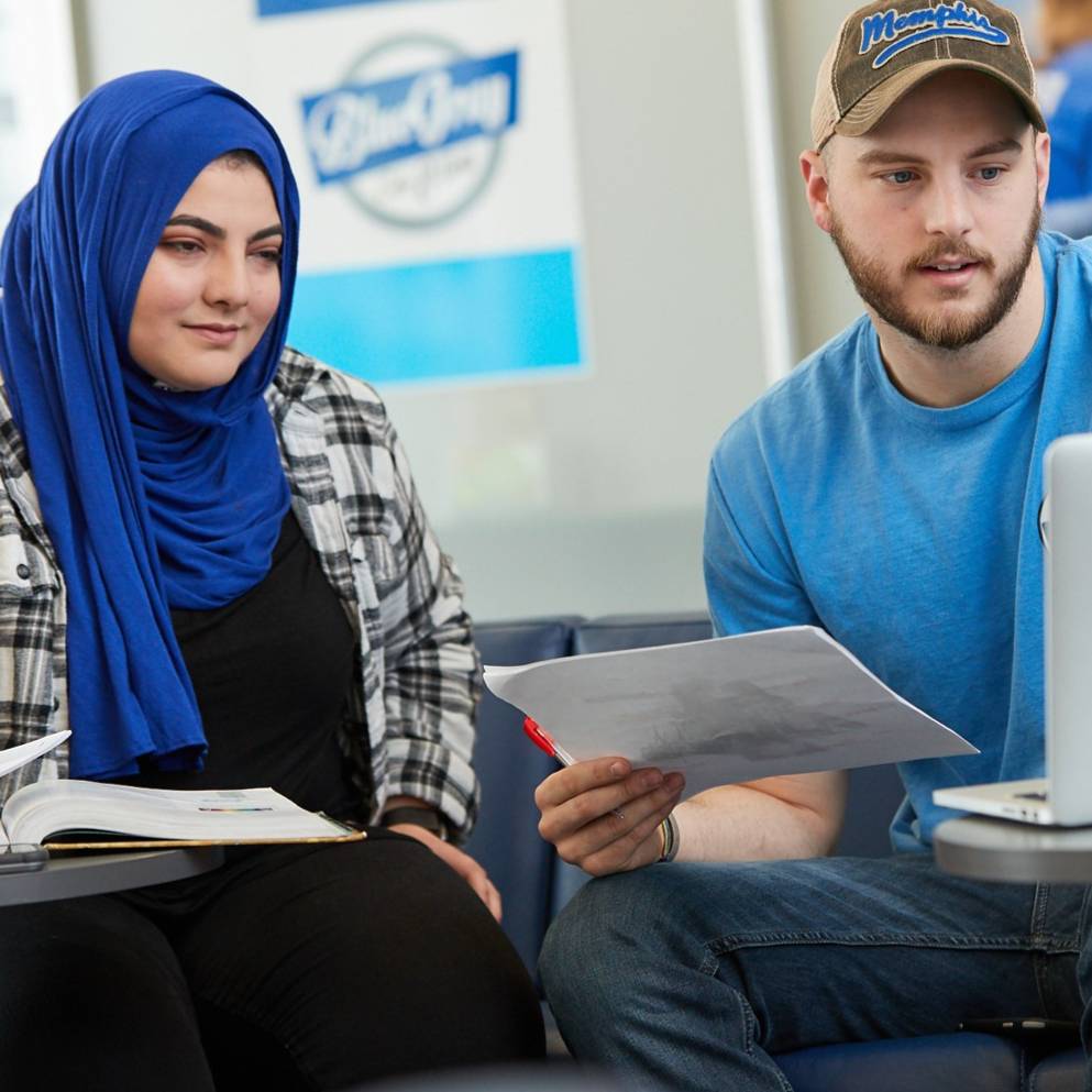 Smiling student sitting on steps