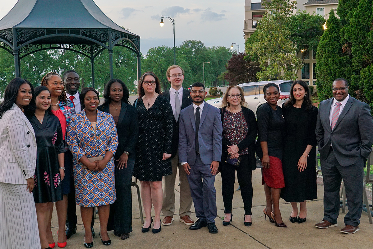 13 graduating HSMP students pose together outside the River Inn of Harbor Town in Downtown Memphis