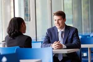 decorative - male in suit speaking to female