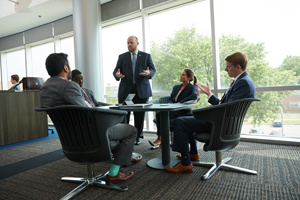 decorative - group of students speaking to professor 