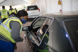 student gives covid vaccine to patient in car