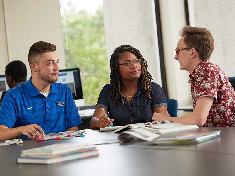 Three students working on a class project