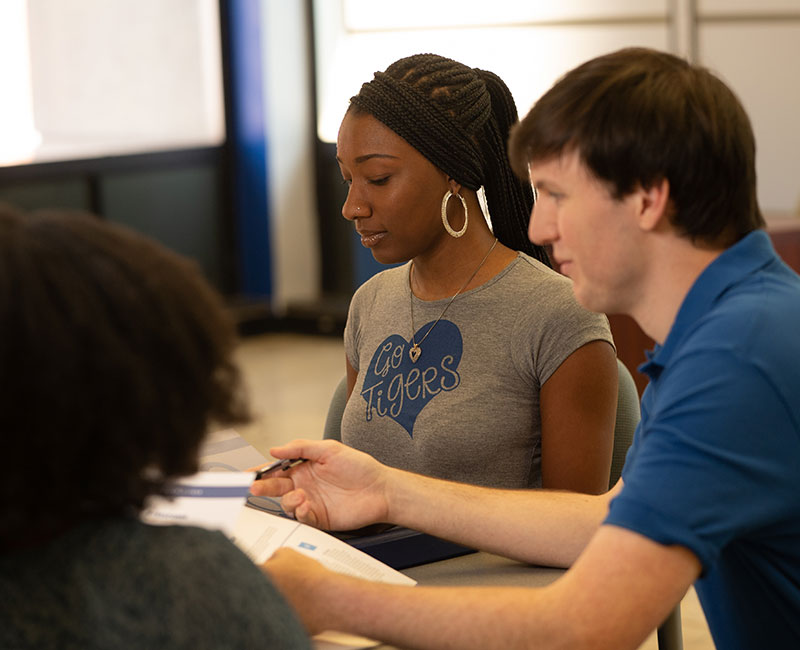Three students working together at a desk