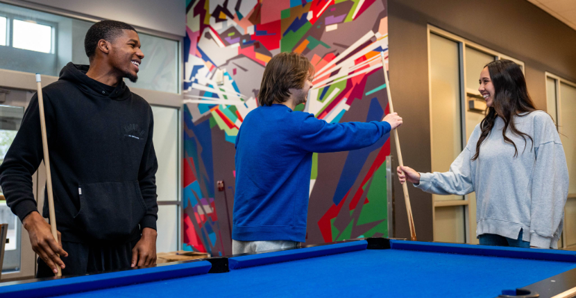 students playing pool in TOMS restaurant in the UC