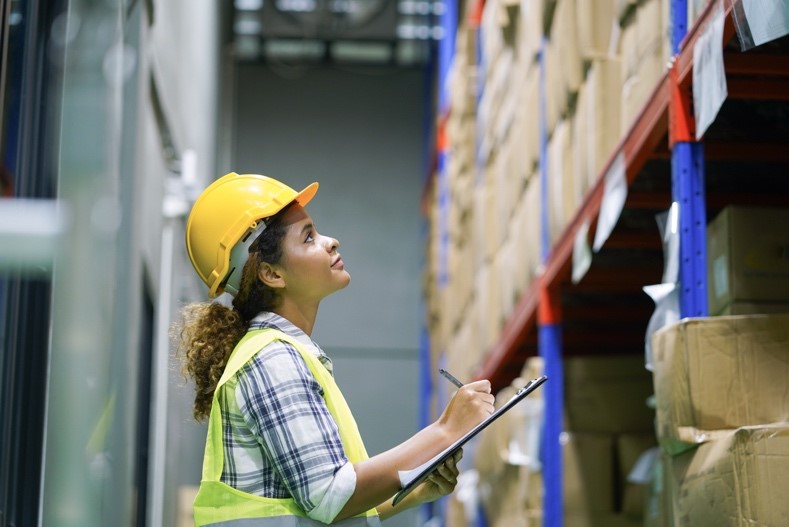 female overseeing supplies and managing a warehouse