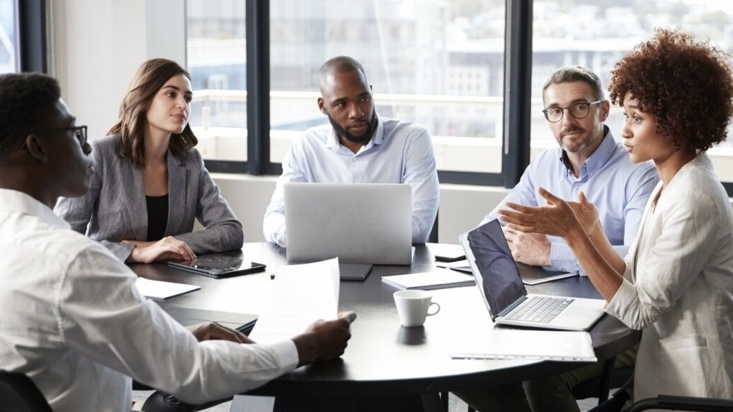 picture of people gathered at table in a meeting