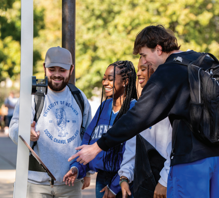 university of memphis students looking at solar system model