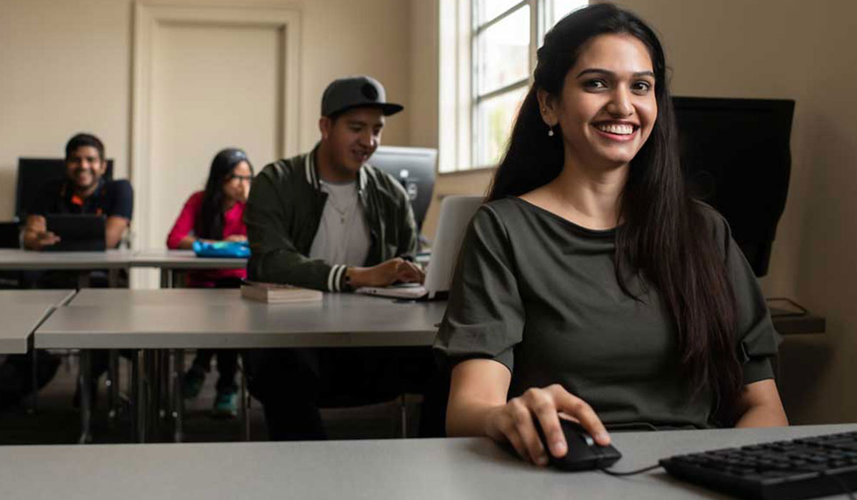 UofM students sitting at long desks with laptops